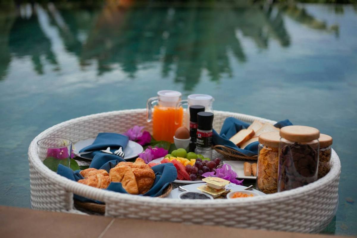 Signature floating breakfast served on a tray in the pool